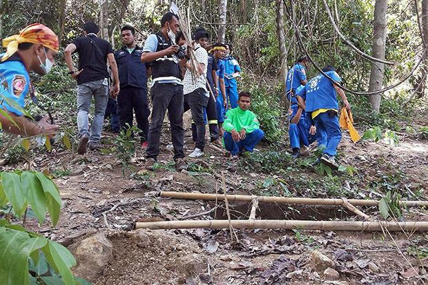 Mass graves unearthed at human-trafficker camp in Songkhla.