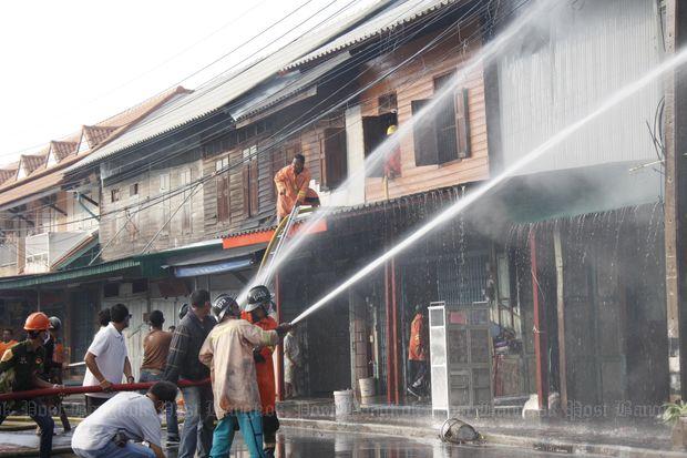 Firefighters try to contain the blaze after the bombing at the Raja Furniture shop in Muang district, Yala province, on May 16, 2015. (Photo by Maluding Tido)